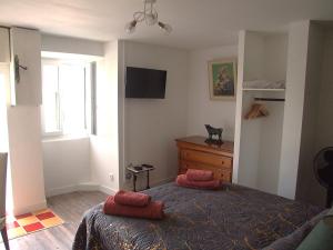 a bedroom with a bed and a dresser and a window at Chez Béa in Pleumartin