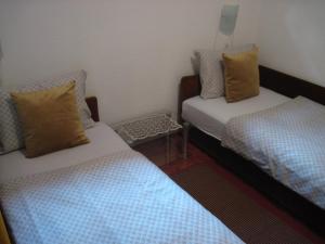 a room with two beds and a small table at Apartment Yasica in Izačić