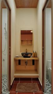 a bathroom with a sink and a toilet at Yên Retreat & Cafe in Cà Mau