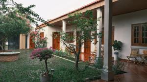 a courtyard of a house with trees and flowers at Yên Retreat & Cafe in Cà Mau