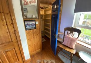 a room with a desk and a chair and a door at Room Stay 4 in Corran Cross Roads