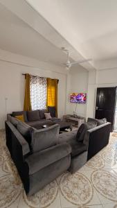 a living room with a couch and a tv at the velvet nest in Watamu