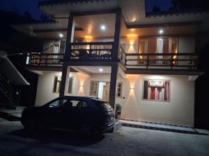 a car parked in front of a house at night at Demazong Homestay in Ravangla