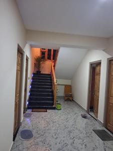 a hallway with a staircase in a building with a stair case at Demazong Homestay in Ravangla