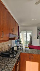 a kitchen with a stove and a counter top at Villa Caesar in Ayia Napa