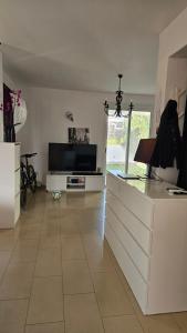 a living room with a kitchen with a counter top at Villa Caesar in Ayia Napa