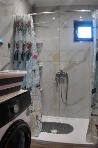 a shower with a glass door in a bathroom at Thea Panorama in Makri +50 photos