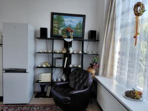 a living room with a chair and a television at Apartman YVET in Sučany