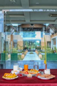a table with plates of food on a red table at Royal Jungle Villas in Sauraha