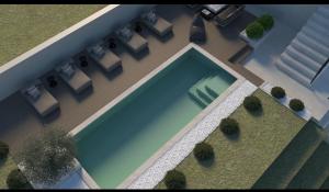 an overhead view of a swimming pool with chairs and plants at Tramonto in Petrovaradin