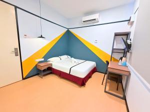 a room with a bed and a desk in a tent at Seeds Hotel Kuala Selangor in Kuala Selangor