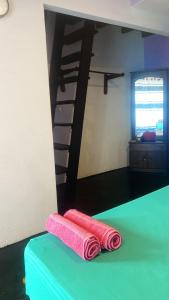 a room with a bed and a spiral staircase at Anya's Loft - Sky Stay in Mirissa