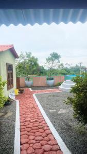 a red brick walkway in front of a house at Anya's Loft - Sky Stay in Mirissa +4 photos