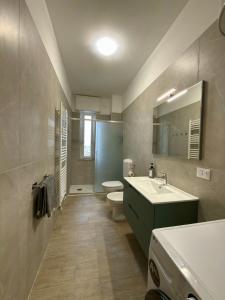 a bathroom with a sink and a toilet and a mirror at SNG - Paggi 78 in Vercelli +6 photos