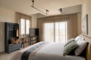 a bedroom with a large bed and a television at Enos Retreat Villas in Agios Nikolaos +72 photos