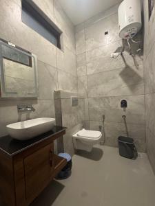a bathroom with a sink and a toilet at Skyview Stays I Party Lawns I Adjacent The Good Club I 1km Sukhna lake,Rock Garden & High Court I in Chandīgarh