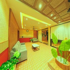 a living room with a couch and a table at Hotel Nakshtra Residency in Bramhapuri