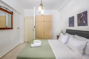 a bedroom with a large bed with towels on it at Casa Di Aspa-Serene Escape with Pool near town in Rethymno +52 photos