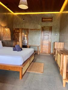a bedroom with a large bed and a table at Roys Villa Sigiriya in Sigiriya
