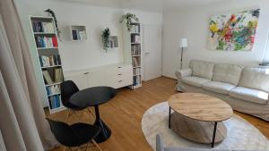 a living room with a couch and a table at Ferienhaus am Main in Veitshöchheim