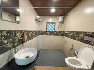 a bathroom with a sink and a toilet at The Rippling Edge - River front property in Karjat