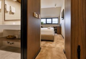 a small room with a bed and a bedroom at Motel Reich in Velenje