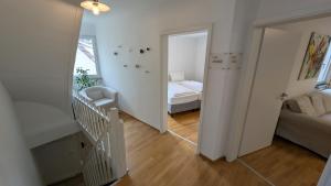a room with a staircase and a bedroom with a bed at Ferienhaus am Main in Veitshöchheim