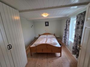 a small bedroom with a bed in a room at Fiskehuset Havnes in Averoy