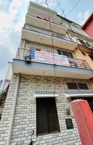 a building with a sign on the side of it at Parvati home stay near by ramjhula,luxmanjhula in Rishīkesh