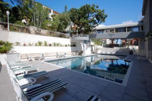a swimming pool with lounge chairs next to a building at Hotel Gaggiano in San Giovanni Rotondo +43 photos