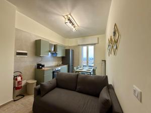 a living room with a couch and a kitchen at SNG - Paggi 78 in Vercelli
