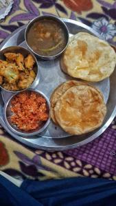 a tray with plates of food on a table at Maa Prabha Courtyard in Varanasi