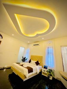 a bedroom with a large bed and a large ceiling at Kings Castle in Varkala