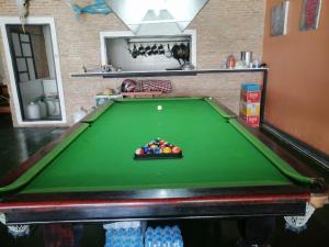 a green pool table with a pile of balls on it at 75 StangStay & Cafe de Art in Ka Rorn