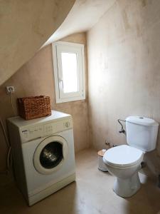 a bathroom with a washing machine and a toilet at Cyclades Serenity Beach House in Kipri +63 photos