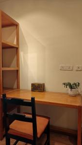 a wooden desk with a potted plant on top of it at Nextdoor Kathmandu in Kathmandu