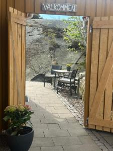 an open door to a patio with a table and chairs at Havsnära boende i Rönnäng in Rönnäng