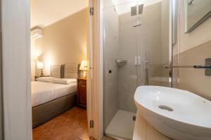 a bathroom with a sink and a shower and a bed at Affittacamere Valentina in Orvieto +89 photos