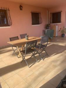 a wooden table and chairs in a room at Location Frejus in Fréjus