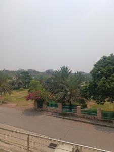 a park with a fence and some trees and flowers at Call it a home in Rawalpindi