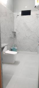 a white bathroom with a tub and a toilet at S&J Hotel & Banquet in Bhabua +9 photos