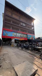 a large building with motorcycles parked in front of it at S&J Hotel & Banquet in Bhabua