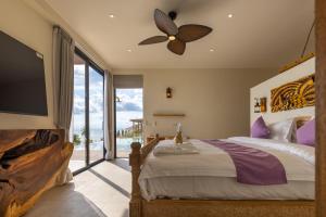 a bedroom with a large bed with a ceiling fan at Villa Bodhi in Ko Phangan +56 photos