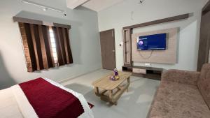 a living room with a couch and a tv at S&J Hotel & Banquet in Bhabua