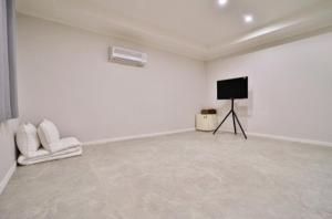 a white room with a television and white walls at Hotel Dongnae in Busan +44 photos