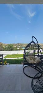a bird cage sitting on top of a patio at Alora House 2 in Kefalos +45 photos