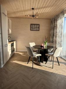 a kitchen and dining room with a table and chairs at Bobrowa Przystań in Bolesławiec +44 photos