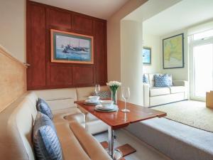 a living room with a couch and a table at 24 The Salcombe in Salcombe