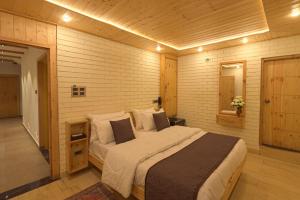 a bedroom with a large bed in a room at PalPenzy - Bespoke Premium Stay in Srinagar +58 photos