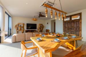 a living room with a wooden table and a couch at Villa Bodhi in Ko Phangan